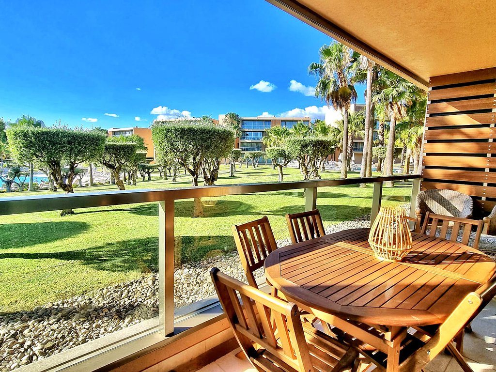 Expansive balcony view from the Luxury T3 Apartment at Salgados Vila das Lagoas, showcasing a tranquil panorama of olive and palm trees, meticulously curated gardens, and glistening pools, inviting relaxation and luxury.